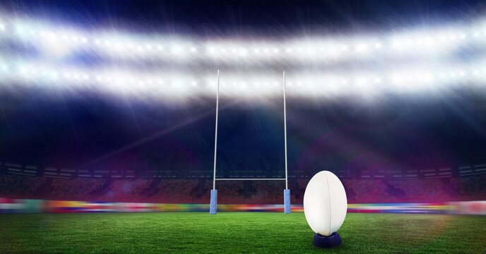 Composition of white rugby ball lying at stadium