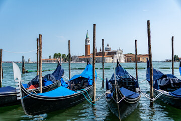 Fototapeta na wymiar Gondolas mored in front of St. Mark's Square with San Giorgio di Maggiore church in the background Venice, Italy