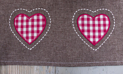 fabric with red pink checkered hearts on wood