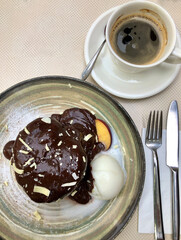 coffee and chocolate cake with ice cream on the table