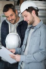 apprentice glazier in the factory with training supervisor