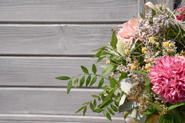 pink and white flowers in front of a wooden background