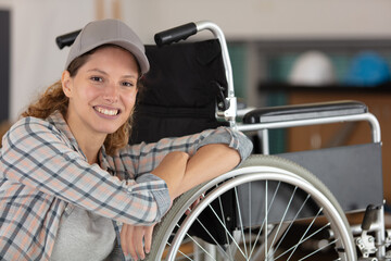 young prety woman is fixing a wheelchair