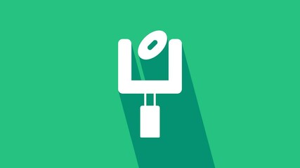 White American football goal post and football ball icon isolated on green background. 4K Video motion graphic animation