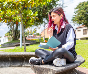 Life after quarantine. Thoughtful attractive young girl with pen in hand thinking on plans writing list to do in notepad