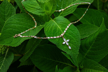 Silver jewelry with purple or violet stone set with pendant and chain.