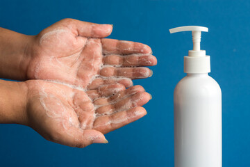 Closeup of person washing hands or using a sanitizing gel. Cleanliness and body care concept.