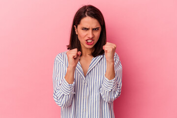 Young caucasian woman isolated on pink background upset screaming with tense hands.
