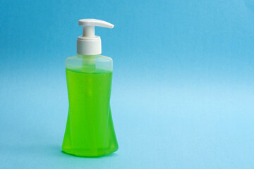 A bottle of sanitizing gel or liquid for washing hands. Cleanliness and body care concept.