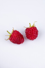 Isolated berries. Bunch of raspberry fruits with leaves isolated on white background, with clipping path