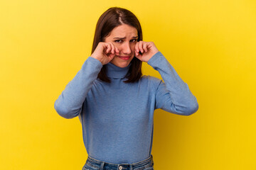 Young caucasian woman isolated on yellow background whining and crying disconsolately.