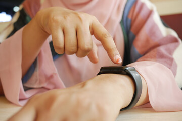 women hand checking time on smart watch,