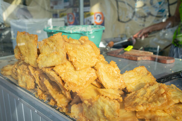 various kinds of fried traditional Indonesian street food, fried tempeh on a serving tray on the table