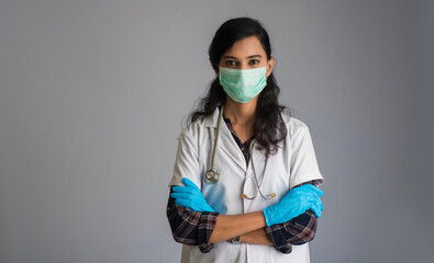 Portrait of woman doctor wearing a protective mask and gloves with a stethoscope. World epidemic of coronavirus concept.