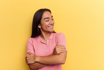 Fototapeta premium Young mixed race woman isolated on yellow background smiling confident with crossed arms.