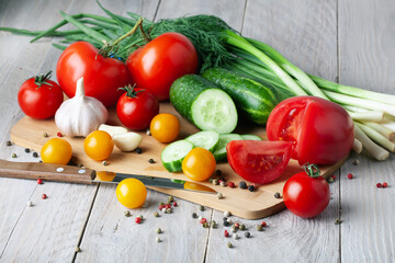Tomatoes, tomato ketchup and tomato juice with lettuce leaves, isolated on a pink background.