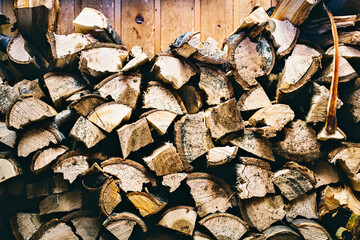 Preparation of firewood for the winter. firewood background, Stacks of firewood in the forest. Pile of firewood.