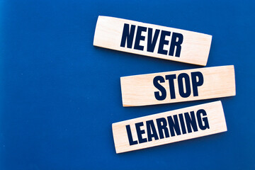Text Never Stop Learning on a wooden blocks. Education concept.