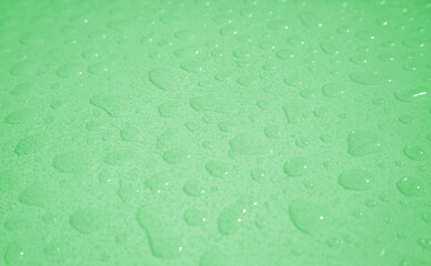 Pop art surreal style sea foam green colored water droplets on the tabletop after the rain	