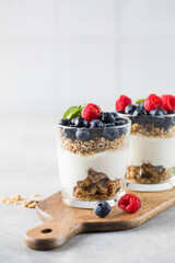 Granola with yogurt, blueberries and raspberries. Healthy breakfast. Menu, recipe.