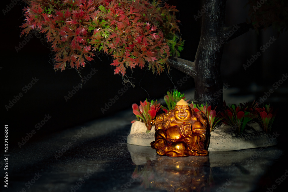 Poster laughing buddha statue on under the tree. statue of laughing buddha. statue of kubera.