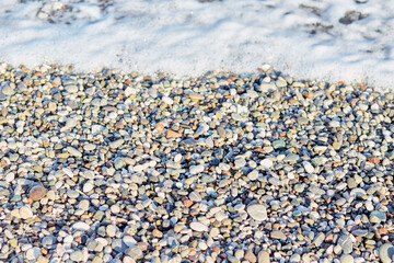 View of the Mediterranean sea and pebbles texture. Summer wallpaper or print. Seamless pattern