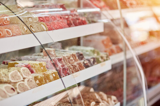 Large selection of Turkish delight in the store. An assortment of colorful Turkish delight and baklava. Turkish National Classic Dessert