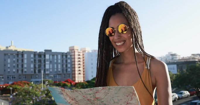 Bohemian mixed race girl looking on city map - Travel and lifestyle concept