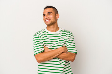 Young venezuelan man isolated on white background dreaming of achieving goals and purposes