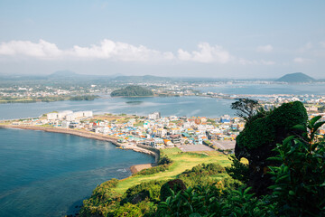 Panoramic view of seaside village from Seongsan Ilchulbong Tuff Cone in Jeju Island, Korea