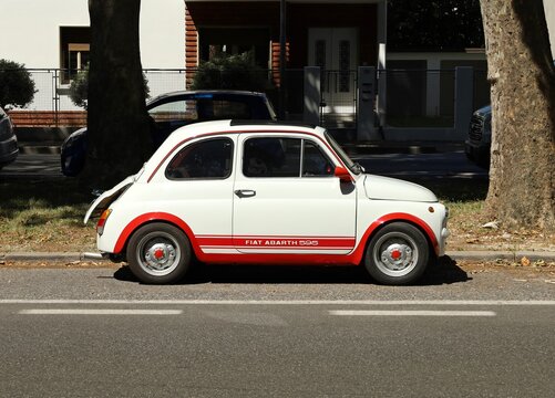 Udine, Italy. June 26, 2021. Fiat 595 Abarth, version of the classic Fiat 500 in the Sixties with the brand and model name written on its side, in an urban street