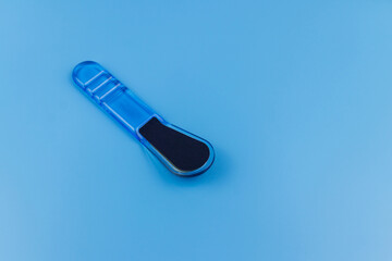 Blue pedicure grater on blue background