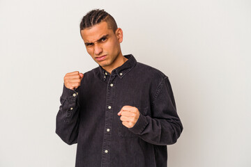 Young venezuelan man isolated on white background showing fist to camera, aggressive facial...
