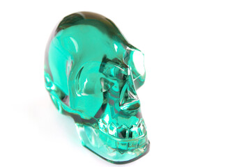 Green glass or crystal skull on white background