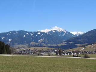 Fototapeta na wymiar beautiful view from train and window of alps in austria spring time still snowy mountains