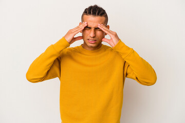 Young venezuelan man isolated on white background having a head ache, touching front of the face.