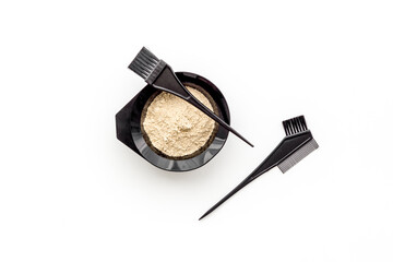 Mixing hair dye in bowl with brush, top view