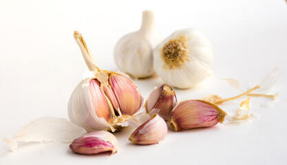 garlic heads and cloves on white background