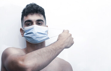 young man finally removing his mask.
free covid