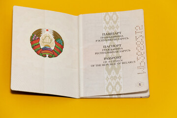 The passport of a citizen of the Republic of Belarus in an expanded form on a yellow background. Close-up