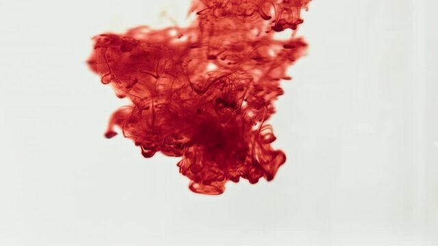 red paint splashes into liquid
