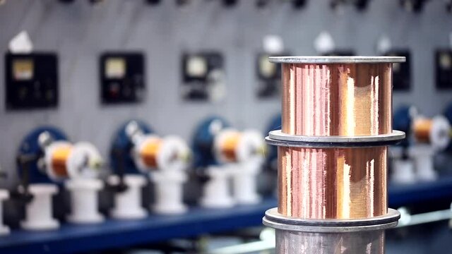 Closeup Coil of copper wire is spun in cable factory.