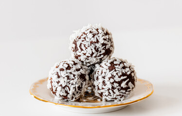 Homemade coconut, cocoa balls on Zsolnay porcelain plate.