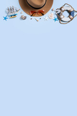 Summer beach background design concept with shells, hat, sunglasses on blue background.