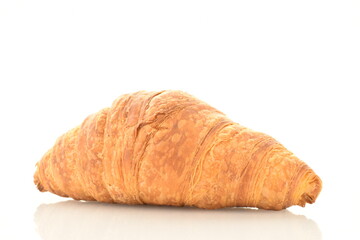 One freshly baked fragrant croissant, close-up, isolated on white.