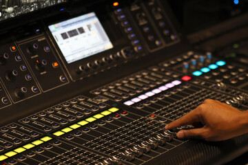 Close up shot of hand adjust  Audio sound mixer&amplifier equipment, sound acoustic musical mixing&engineering concept background, selective focus .control room of a recording studio