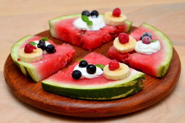delicious summer dessert watermelon slices with berries close-up