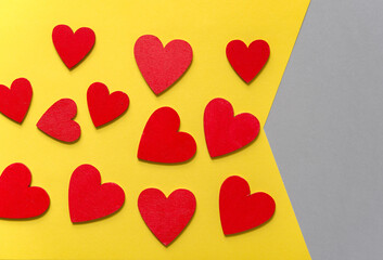 red hearts on yellow and gray paper background