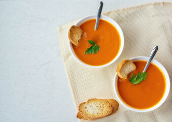 Pumpkin soup cream with crackers on a white table. The concept of healthy eating. Diet.