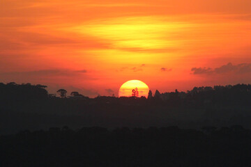 sunset in the mountains over the florest